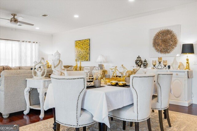 dining space featuring dark hardwood / wood-style floors, ceiling fan, and crown molding