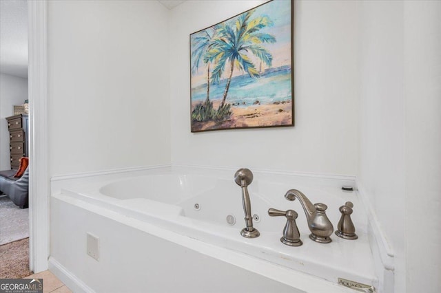 bathroom with tile patterned floors and a tub with jets