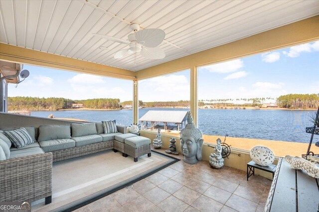 view of patio / terrace with an outdoor living space, a water view, and ceiling fan