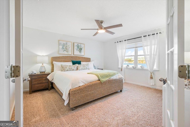 bedroom with carpet, baseboards, and ceiling fan