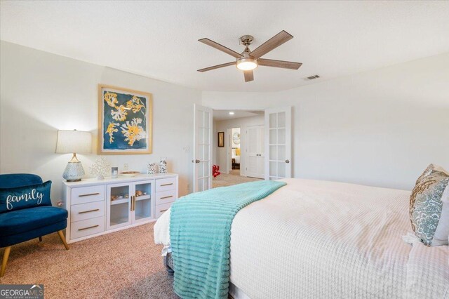 carpeted bedroom with ceiling fan and french doors