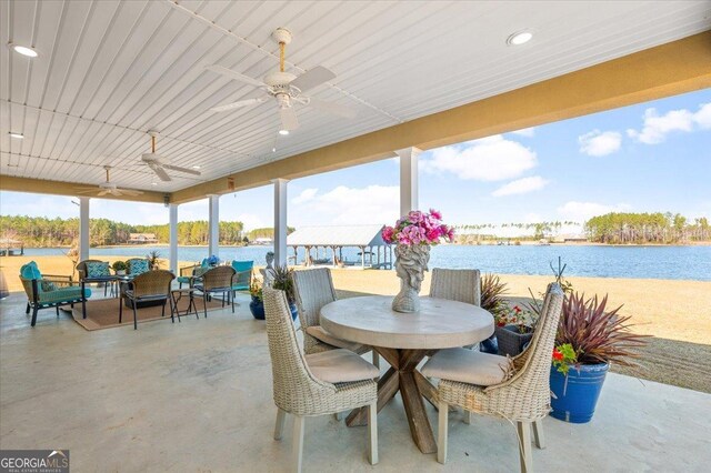 exterior space featuring ceiling fan and a water view