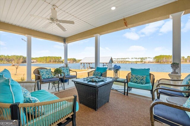 view of patio featuring an outdoor living space, ceiling fan, and a water view