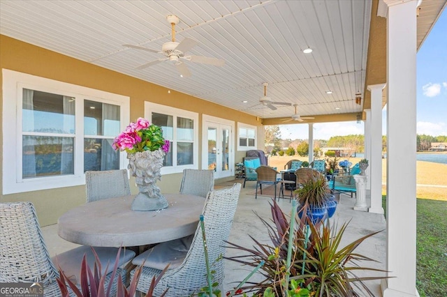 view of patio / terrace featuring outdoor dining space, french doors, and a ceiling fan