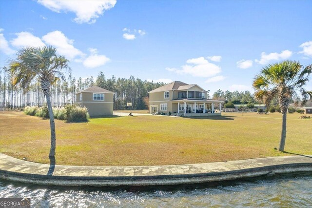 view of property's community featuring a water view and a yard