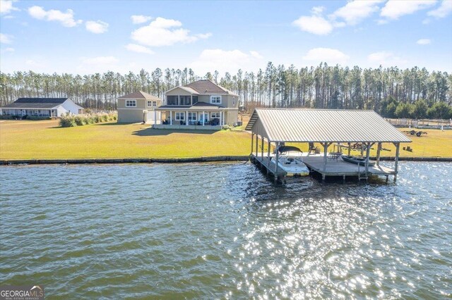 view of dock with a water view and a lawn