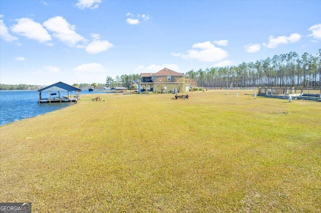 view of yard with a dock and a water view