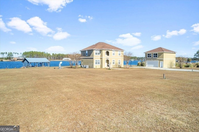 view of front of home with a garage and a water view