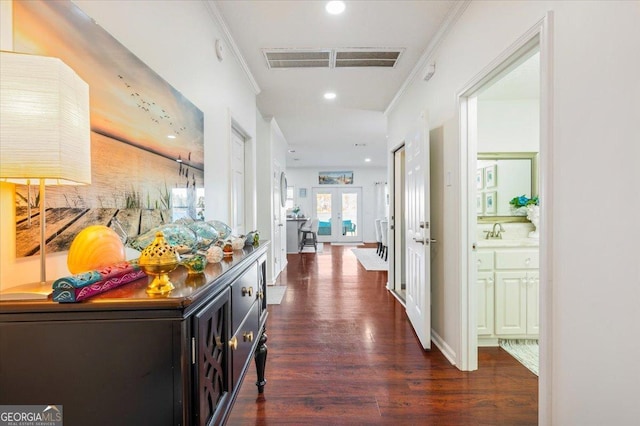 corridor featuring visible vents, dark wood-type flooring, crown molding, recessed lighting, and french doors