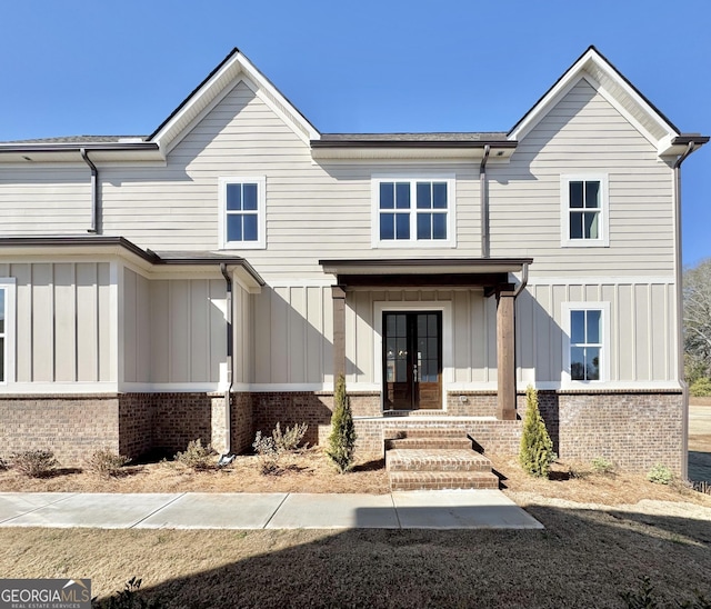 view of front of house featuring a porch and french doors