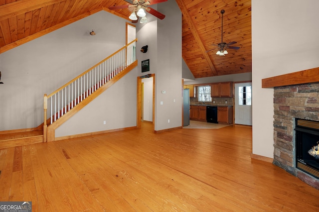 unfurnished living room featuring a fireplace, light hardwood / wood-style flooring, ceiling fan, and wooden ceiling