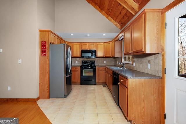 kitchen featuring wooden ceiling, black appliances, sink, vaulted ceiling with beams, and a healthy amount of sunlight