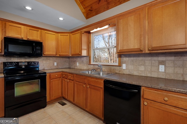 kitchen with sink, vaulted ceiling, decorative backsplash, light tile patterned floors, and black appliances