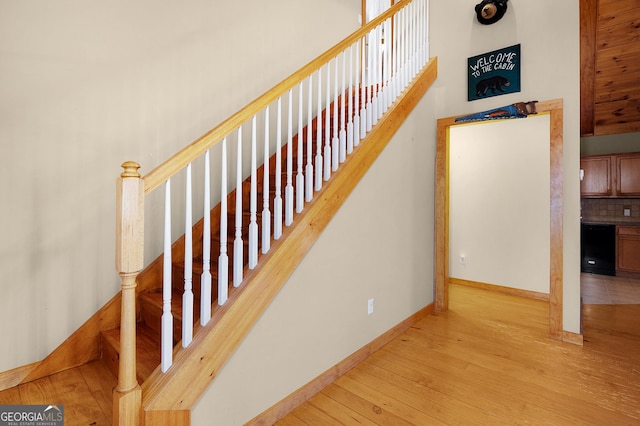 stairway with hardwood / wood-style floors