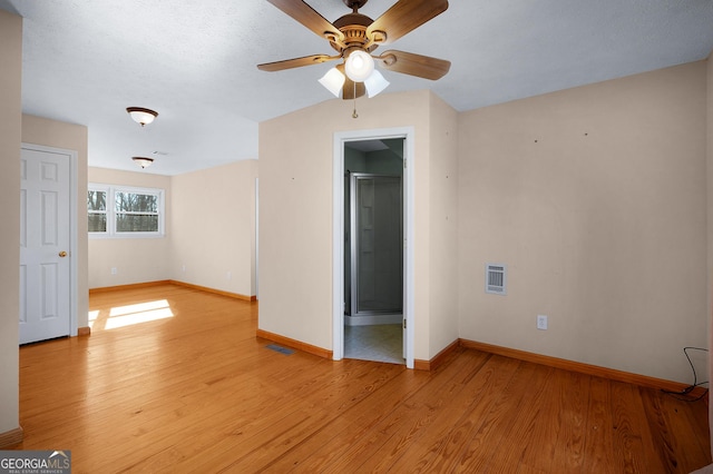 empty room featuring ceiling fan and light hardwood / wood-style floors