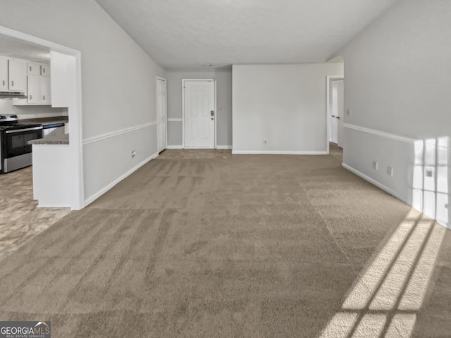 unfurnished living room featuring light colored carpet