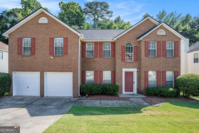 view of front of home with a front lawn and a garage