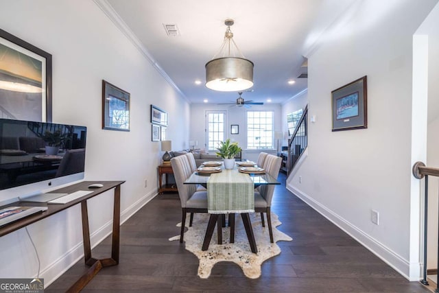 dining room featuring crown molding, dark hardwood / wood-style flooring, and ceiling fan