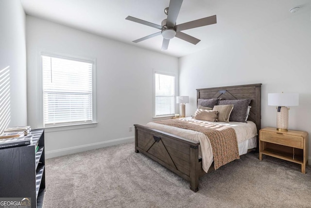 bedroom with ceiling fan and light colored carpet