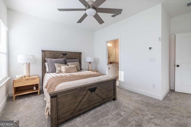 bedroom featuring connected bathroom, ceiling fan, and light colored carpet