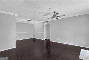 unfurnished room featuring dark hardwood / wood-style flooring and ornamental molding