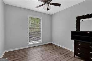 interior space with ceiling fan and wood-type flooring