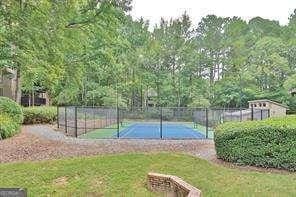 view of sport court with a yard and tennis court