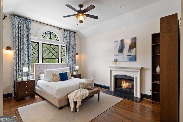 bedroom with ceiling fan, dark hardwood / wood-style flooring, and lofted ceiling