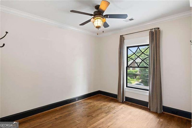 unfurnished room featuring light hardwood / wood-style floors, ornamental molding, and a wealth of natural light