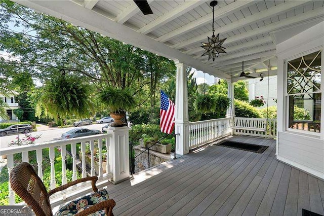 wooden terrace with covered porch and ceiling fan