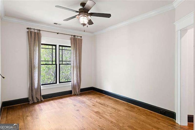 spare room with crown molding, ceiling fan, and hardwood / wood-style flooring