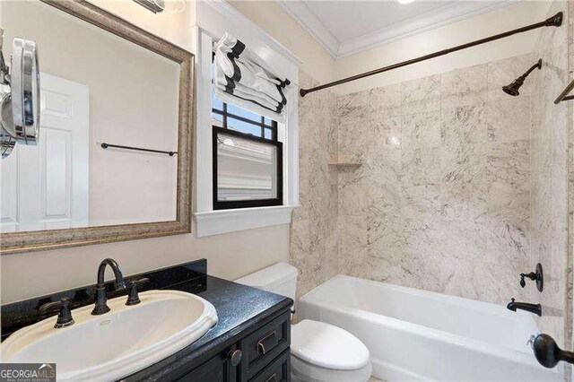 full bathroom with vanity, toilet, ornamental molding, and tiled shower / bath