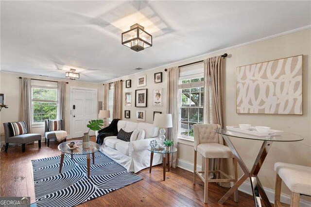 living room featuring dark hardwood / wood-style floors and ornamental molding