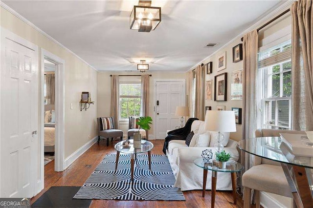 living room featuring crown molding, plenty of natural light, and hardwood / wood-style floors