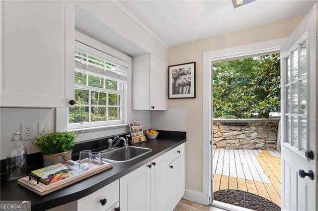 kitchen with white cabinetry and sink