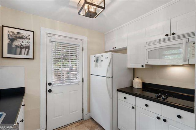 kitchen with white cabinetry and white appliances