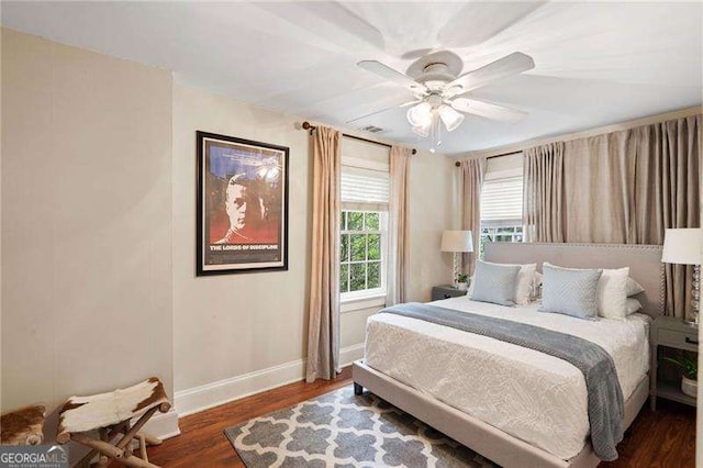 bedroom with ceiling fan and dark wood-type flooring