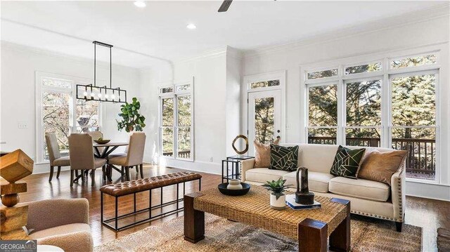 sunroom / solarium with ceiling fan with notable chandelier and a healthy amount of sunlight