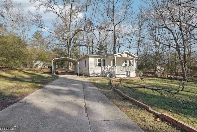 view of front of home with covered porch, a carport, and a front yard