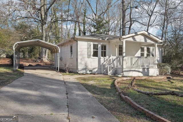 view of front of house with covered porch, a front lawn, and a carport