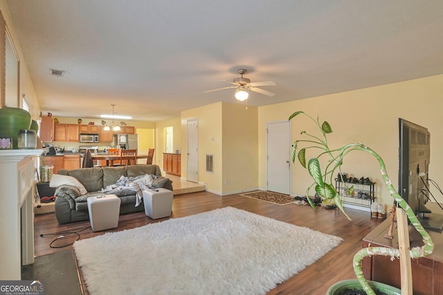 living room with ceiling fan and wood-type flooring