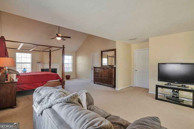 bedroom with ceiling fan, light colored carpet, and lofted ceiling