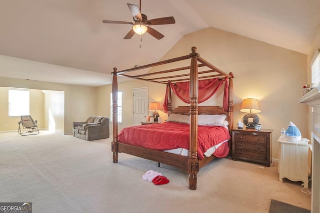 carpeted bedroom featuring ceiling fan and vaulted ceiling