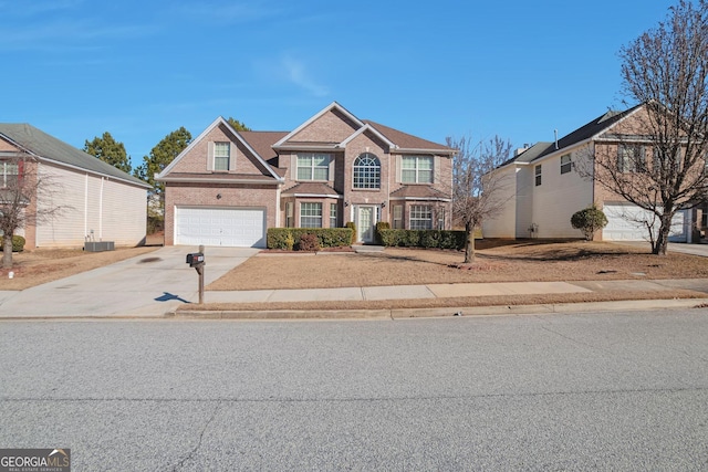 view of front of property with a garage and central air condition unit