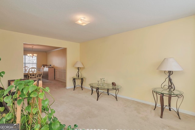 living area with light carpet and a chandelier