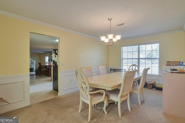 carpeted dining room featuring crown molding and a notable chandelier