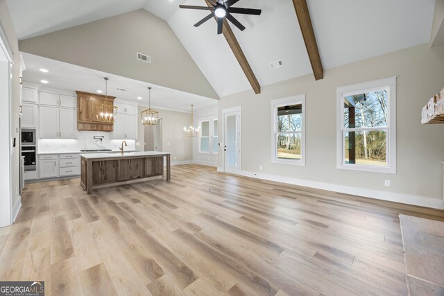 spare room with a notable chandelier and lofted ceiling