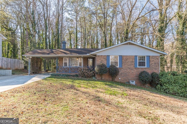 ranch-style home with a front yard, a porch, and a carport