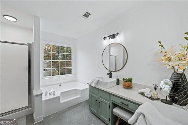 bathroom with vanity and shower with separate bathtub