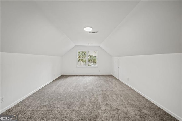 bonus room with carpet flooring and lofted ceiling